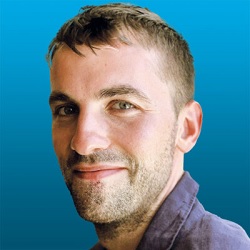 Side profile headshot of Dr Gareth Patterson from the shoulders up smiling.