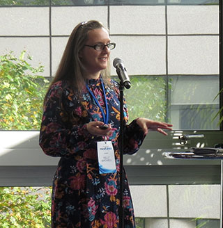 A square photo of Dr Kelly Birtwell wearing a black flowery dress. 