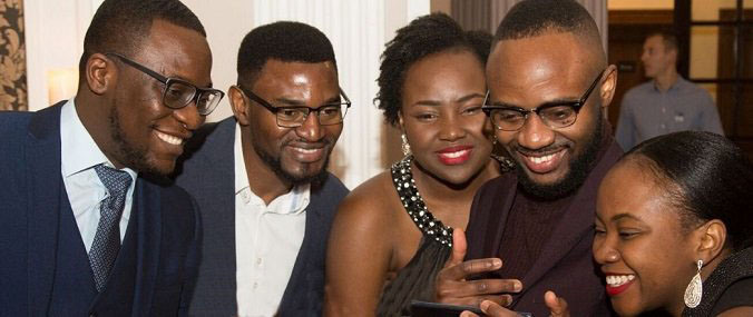 A group of people smiling at a phone