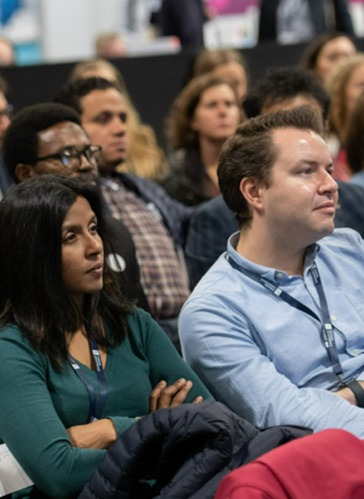 A group of seated GPs attending an event. 