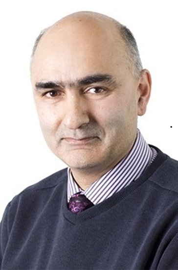 A head and shoulders photo of Dr Imran Rafi wearing a navy jumper over a shirt and tie. 