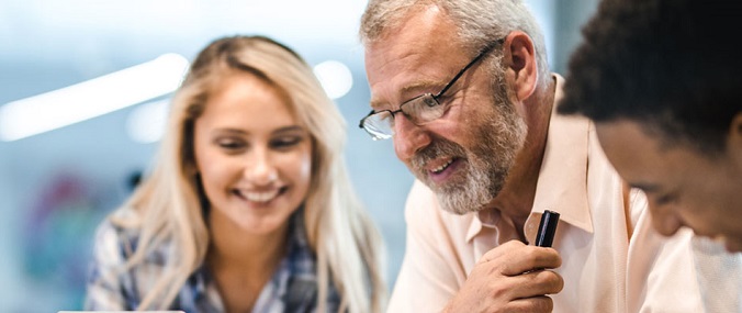 Three people smiling in discussion