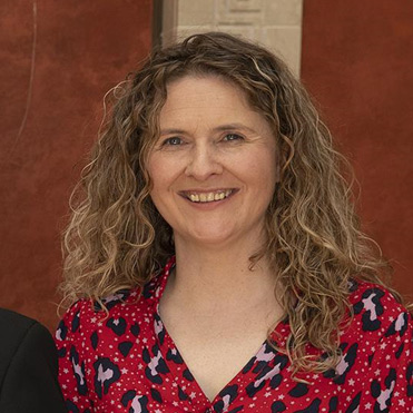 Headshot of Emma Murtagh wearing red leopard print top