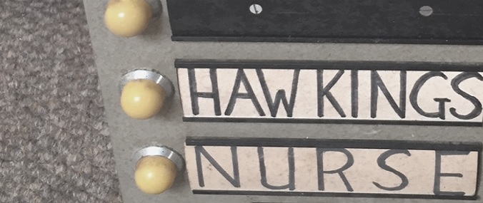 Two names on an old machine indicating doctor availability