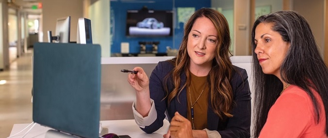 Two women looking at a laptop