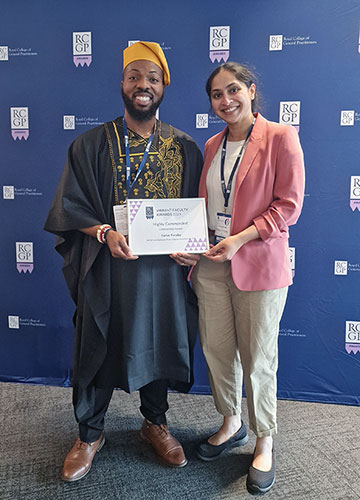 IMG Lead Tochi Achonye and Deputy Faculty Chair Deepthi Lavu stand in front of a blue RCGP backdrop, holding a certificate. 