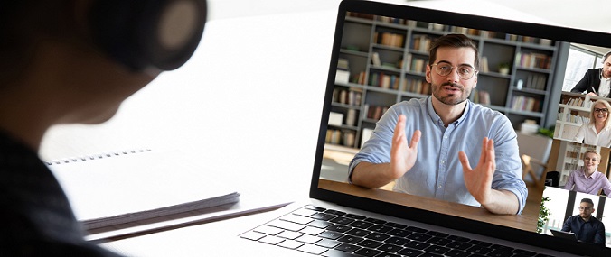 A person watching a webinar on a laptop