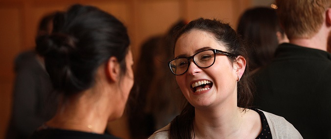Two women laughing in conversation