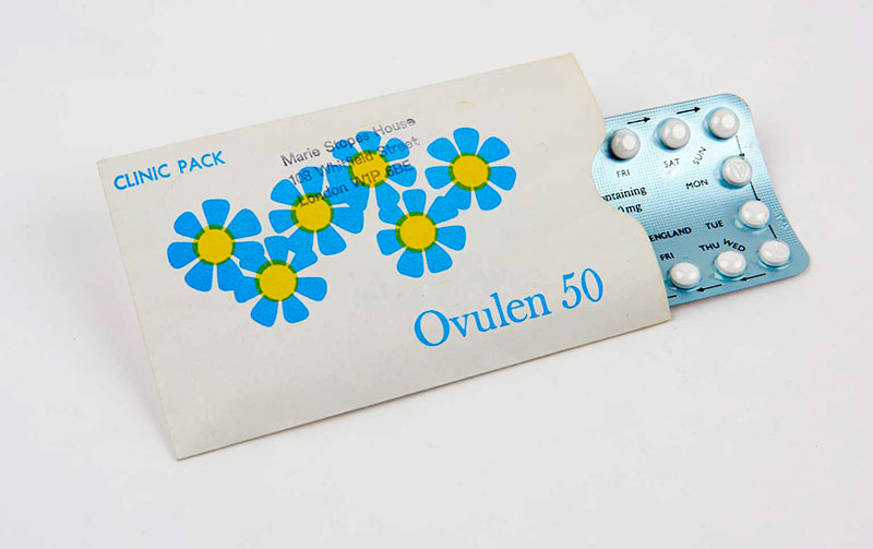 A vintage pack of Ovulen 50 contraceptive pills partially pulled out from a floral-design sleeve labelled "Clinic Pack." © The Board of Trustees of the Science Museum 