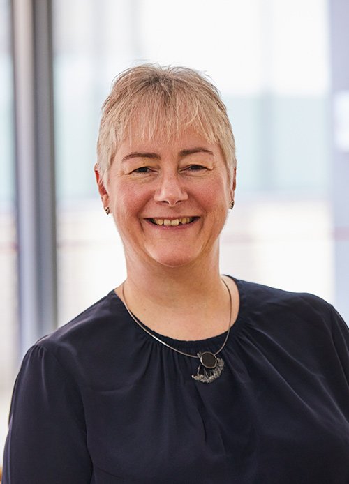 A portrait photo of Dr Jeanette Dickson wearing a black top.