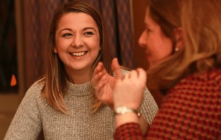 Two people talking and smiling